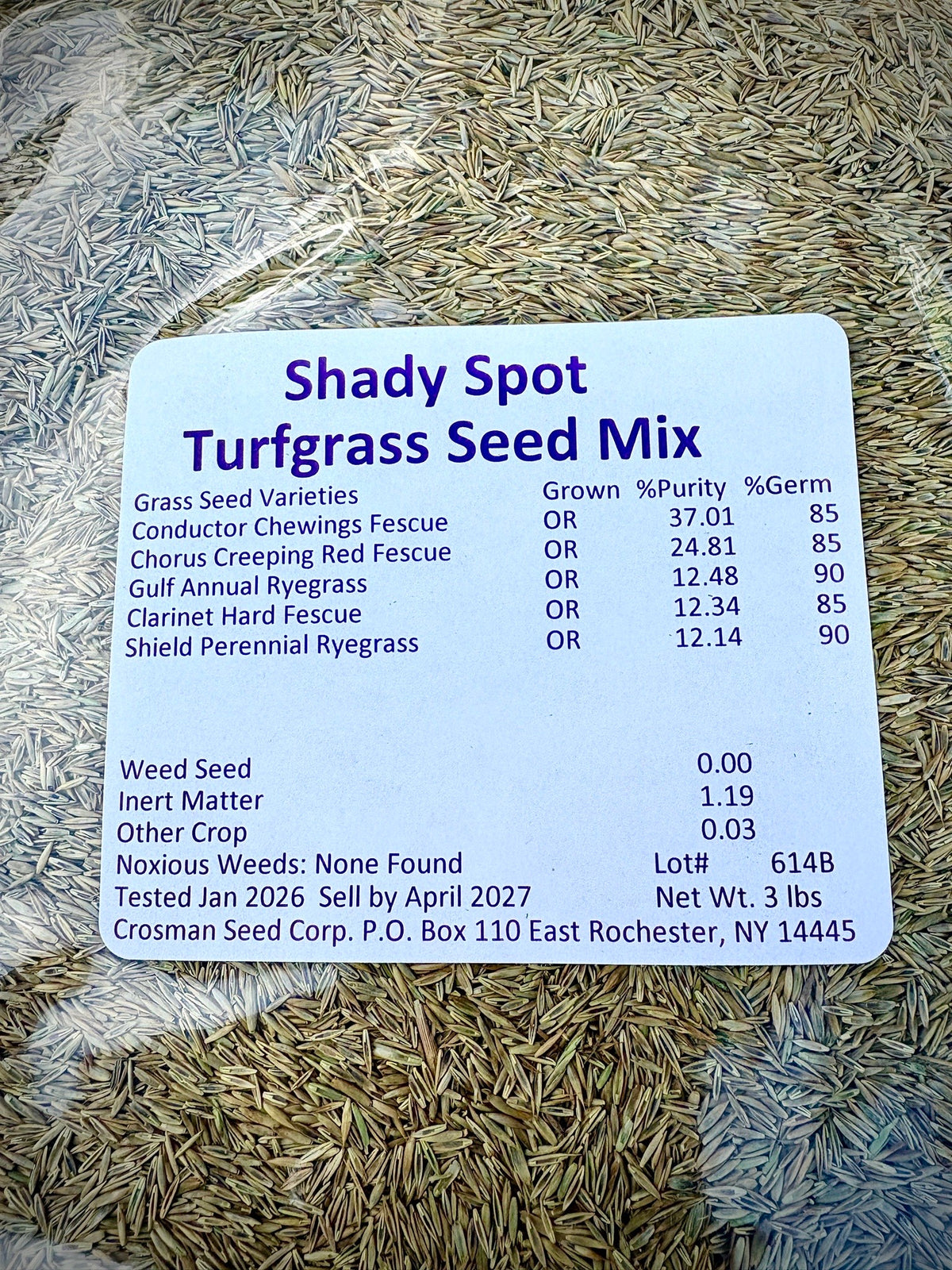 Turfgrass seed mix label with seed texture in the background